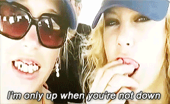 a home video of Taylor and her friend with hats and fake teeth in as the song says &quot;I&#x27;m only up when you&#x27;re not down&quot;