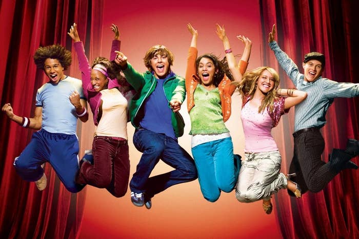 The main cast of High School Musical jumping into the air gleefully