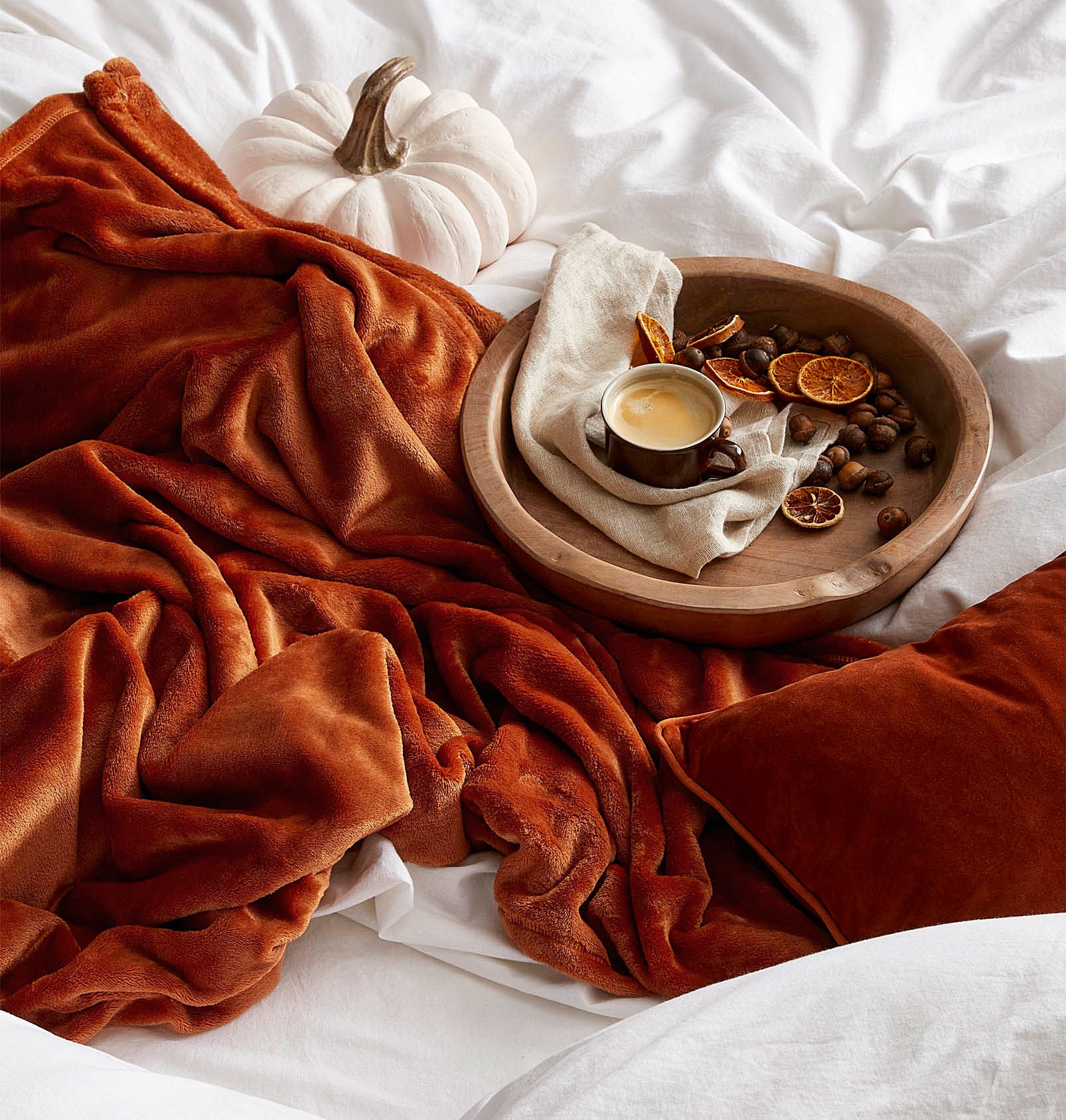 A fuzzy blanket in a pile on a bed
