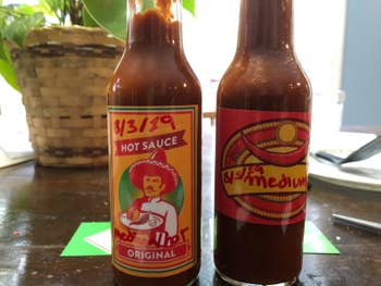 reviewer image of two hot sauces they made in labeled bottles