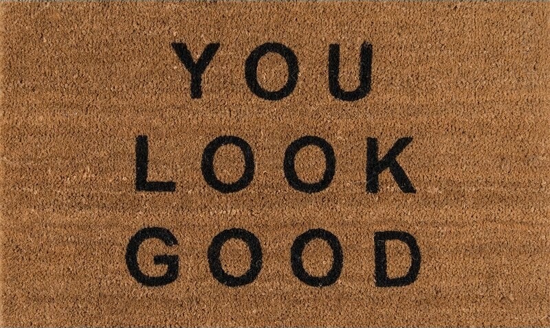 Brown doormat with black letters