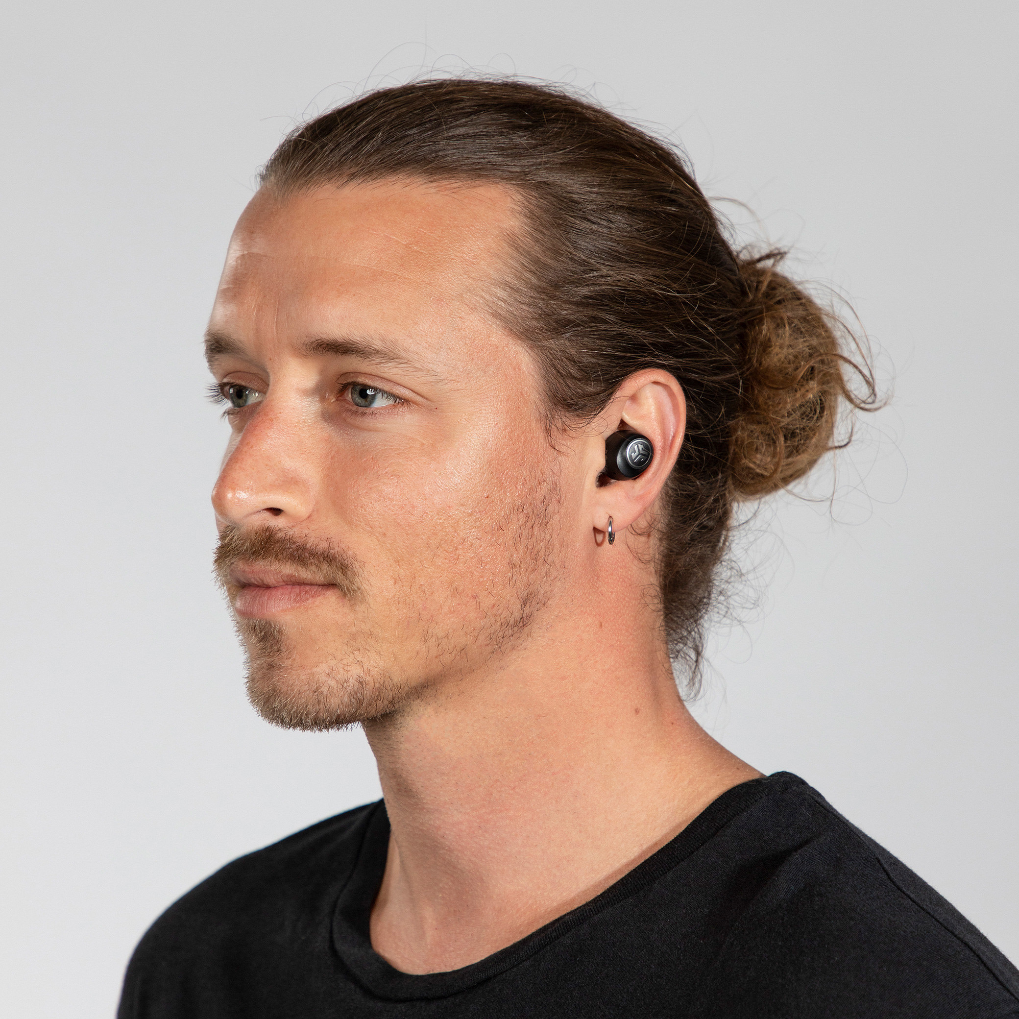 A model wearing the earbuds