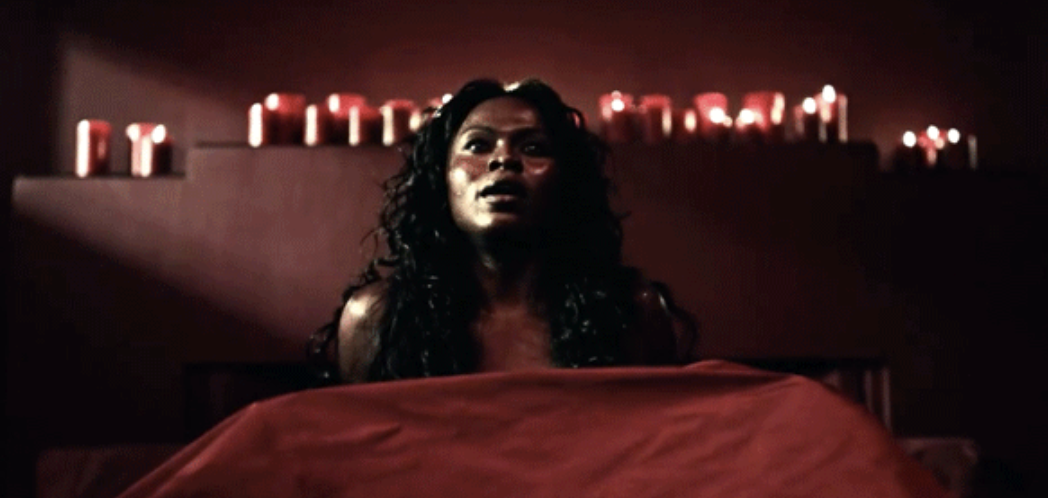 A woman lying in bed with red sheets covering her in &quot;American Gods&quot;