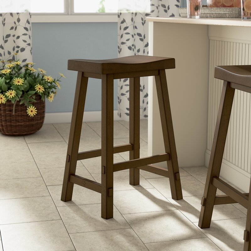 A brown wooden bar stool