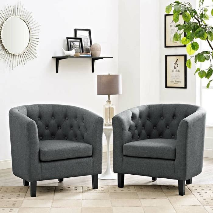 Two gray tufted arm chairs with round backs