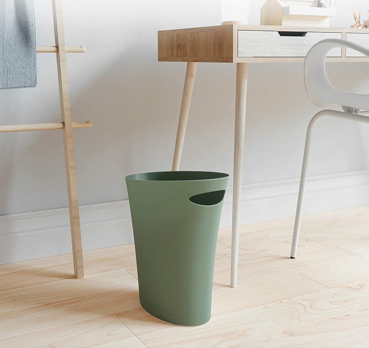  a garbage bin that is slim enough to fit in small spaces