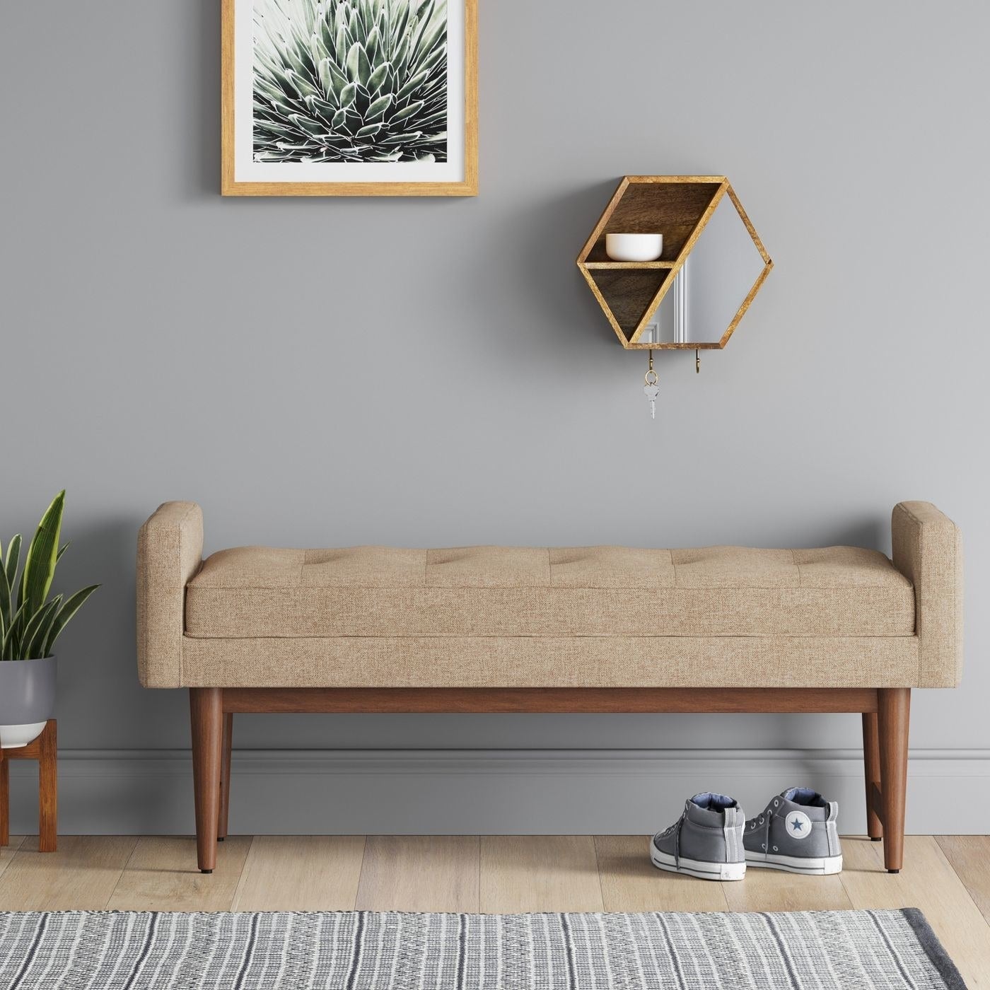 Mid-century modern bench with wooden legs and tufted upholstery