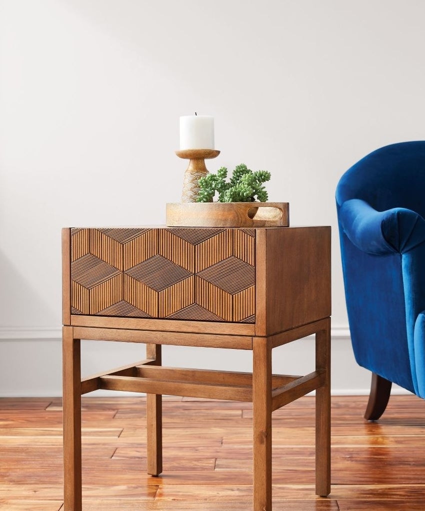 Brown side table with chevron design on front drawer