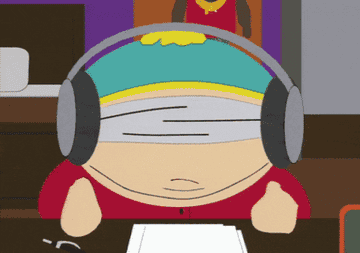 Cartman sits at his desk, blindfolded with headphones on, on South Park