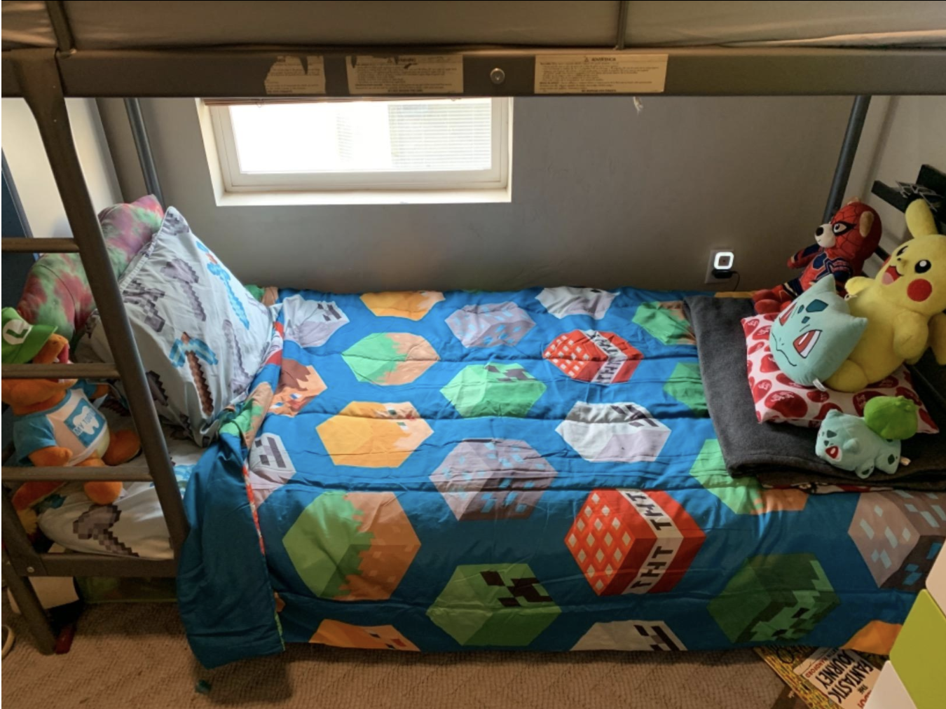 A reviewer photo of the bed set on the bottom of a bunk bed. 