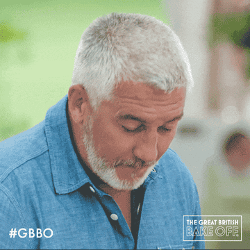 Paul Holllywood makes a face as he tastes something sour, pursing his lips and squeezing his eyes shut on The Great British Bakeoff