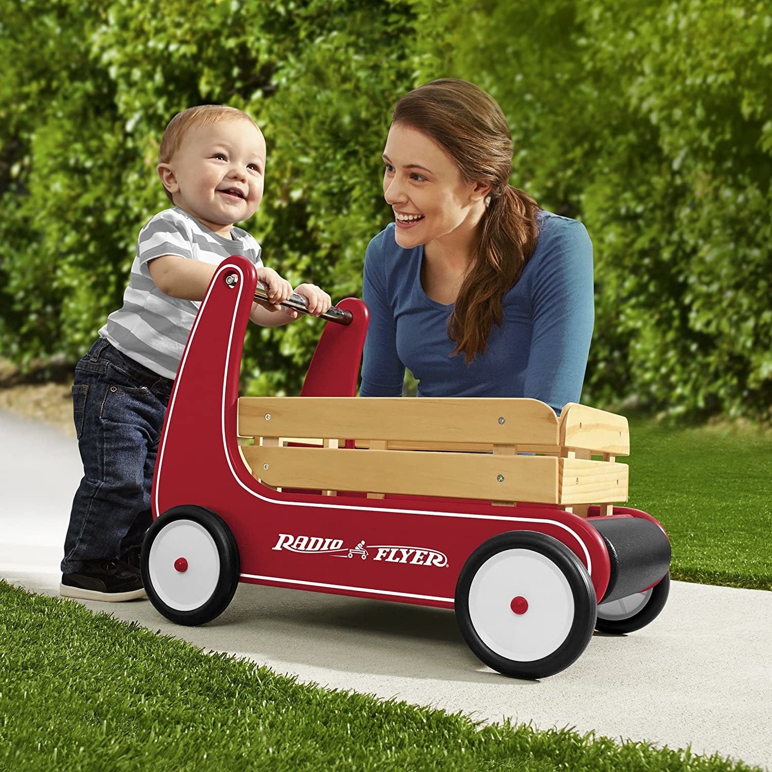 Model and child playing with red radio flyer wagon with side wood paneling