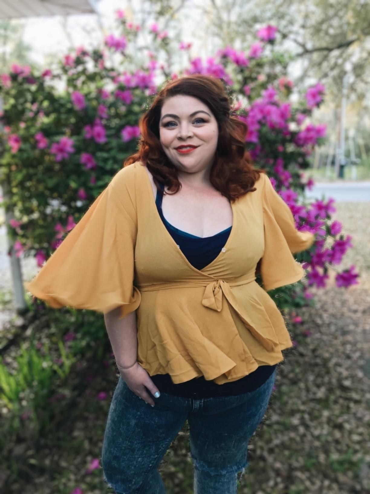 Reviewer wearing the peplum top with a tie around the waist in yellow
