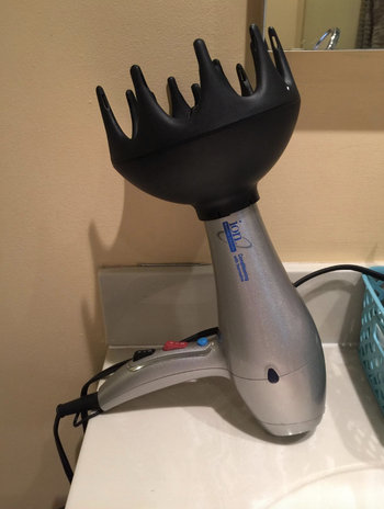 The black wide diffuser attachment on a standard hair dryer 