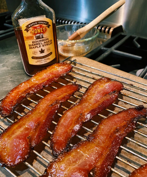 Syrup-covered bacon drying on rack 