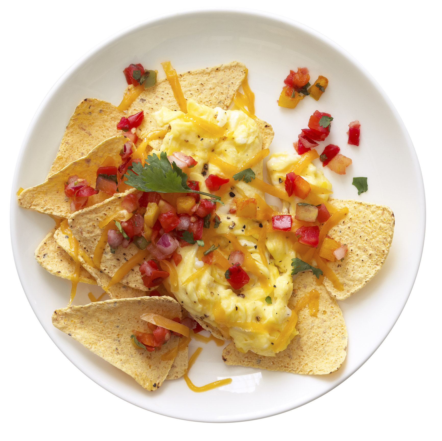 Scrambled eggs on tortilla chips with shredded cheese and pico de gallo.
