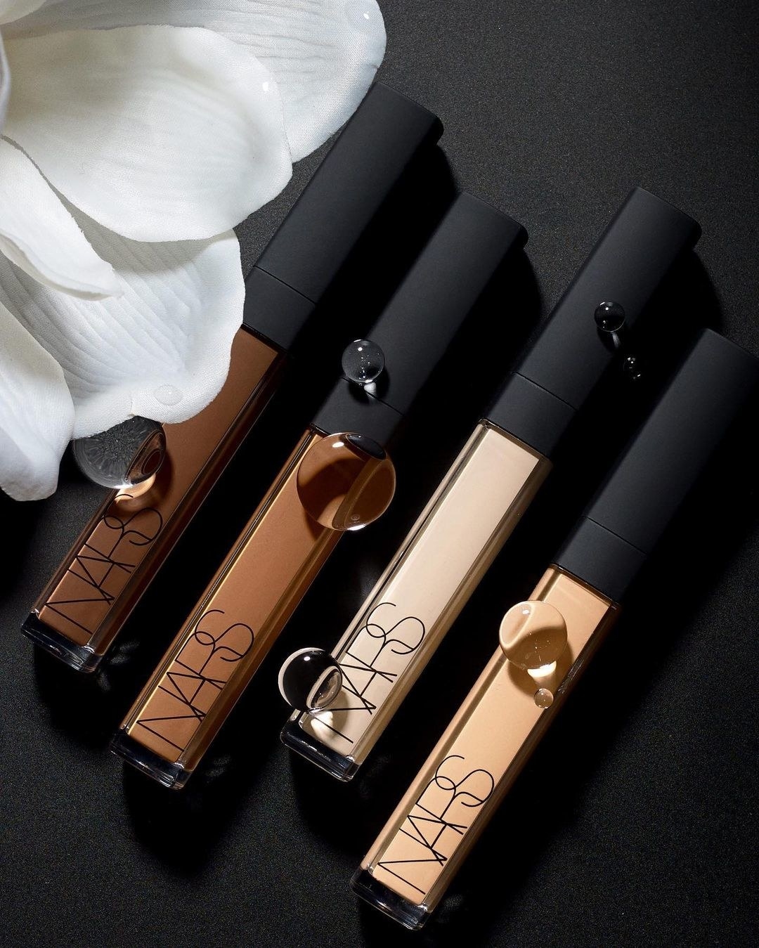 NARS concealer styled on a table in a variety of shades
