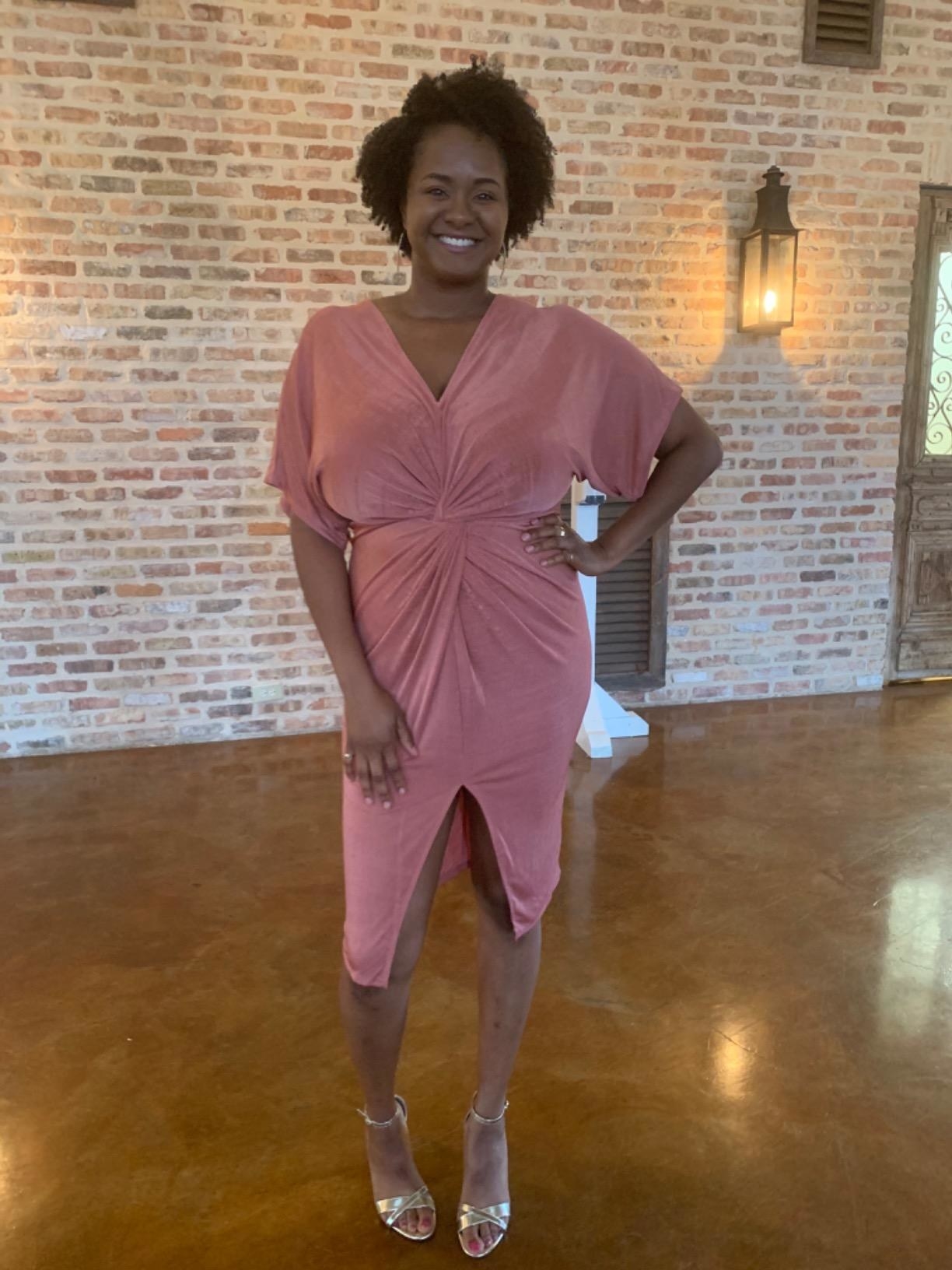Reviewer wearing the dress with a slit up the bottom middle in light pink
