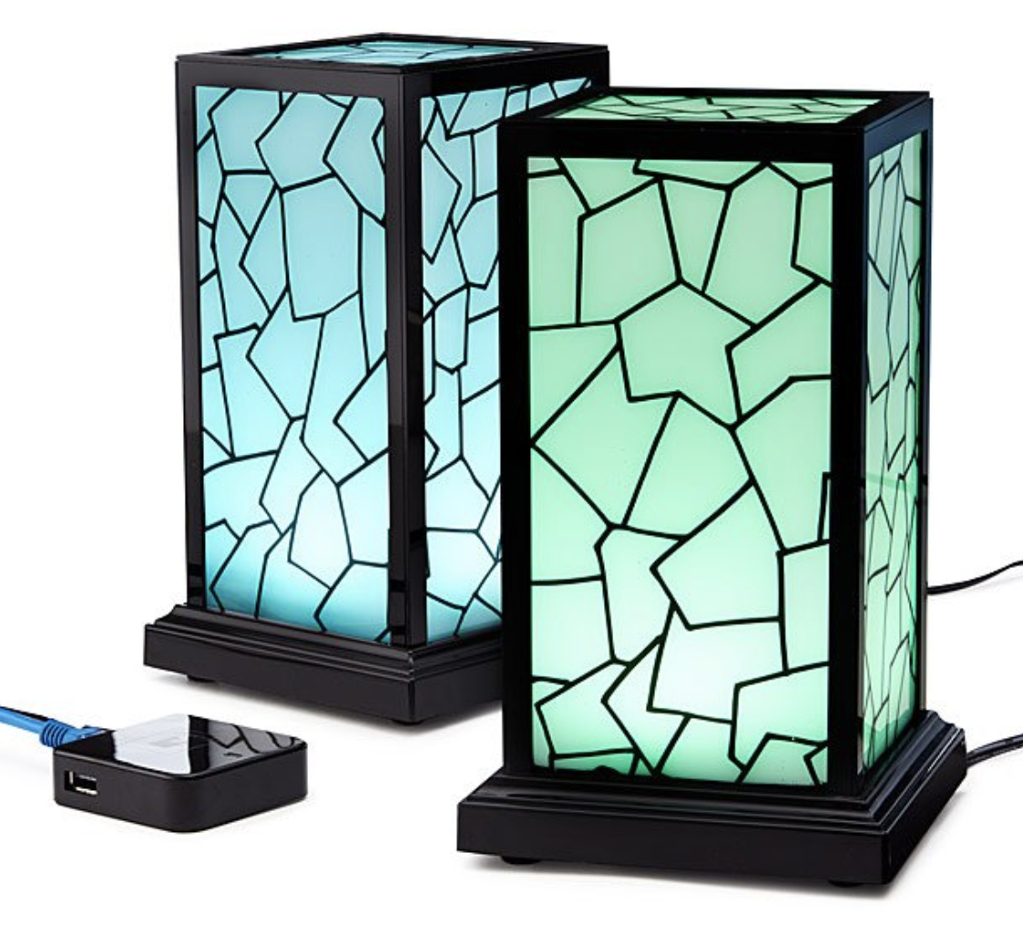 Two brightly lit rectangular devices that are glowing near a Wi-Fi router