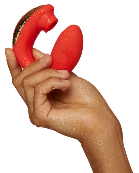 A model's wet hand holds the BuzzFeed AirVibe
