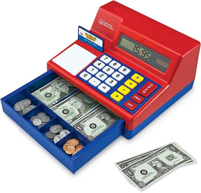A toy cash register with play money