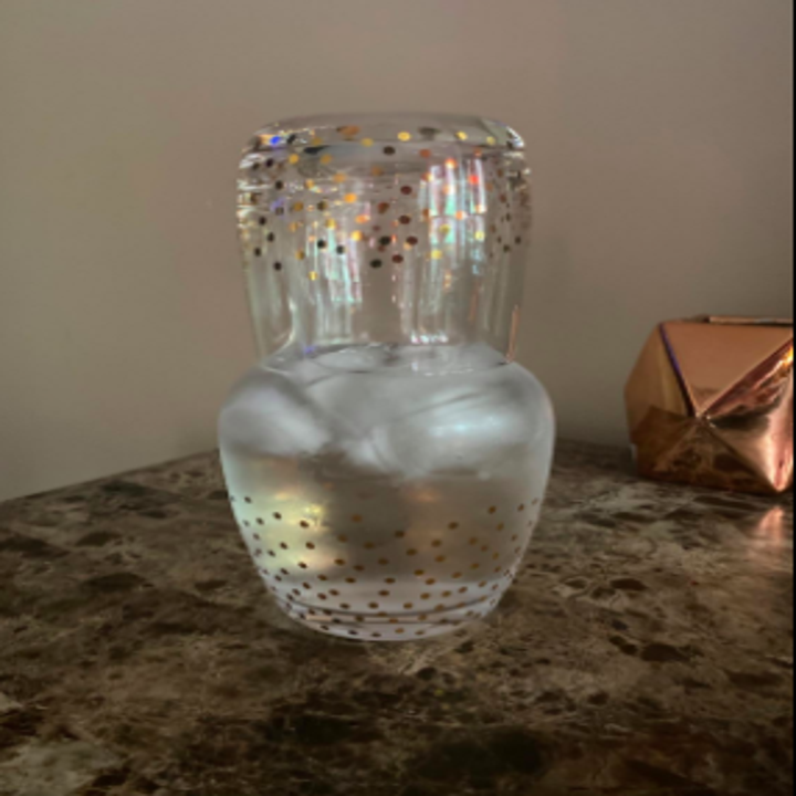 reviewer's pic of the carafe with cup on it on a nightstand