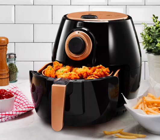 The air fryer filled with freshly-made chicken wings