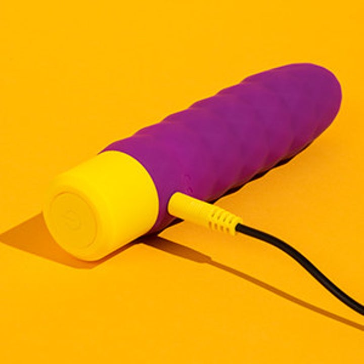 the ROMP beat bullet vibrator plugged into its charger