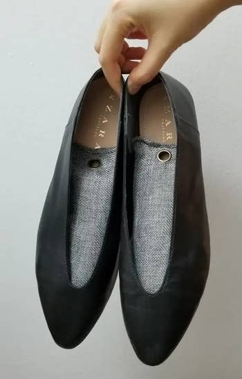 Photo of BuzzFeeder holding shoes with bamboo charcoal shoe deodorizers in them