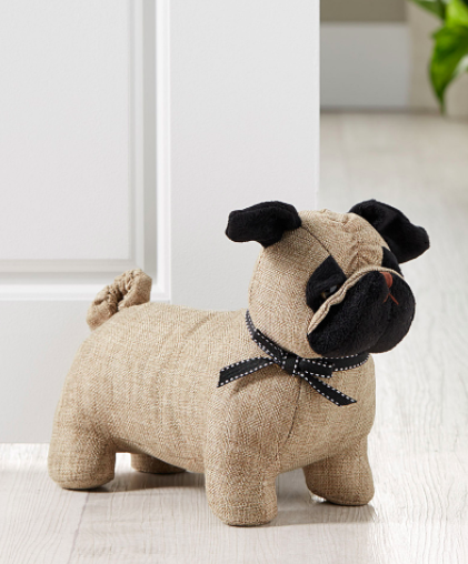 A pug shaped door stop propping open a door