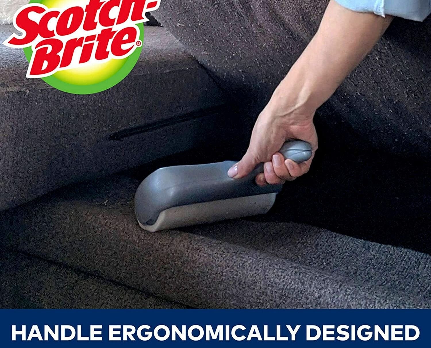 person rolling under a couch cushion with the large lint roller