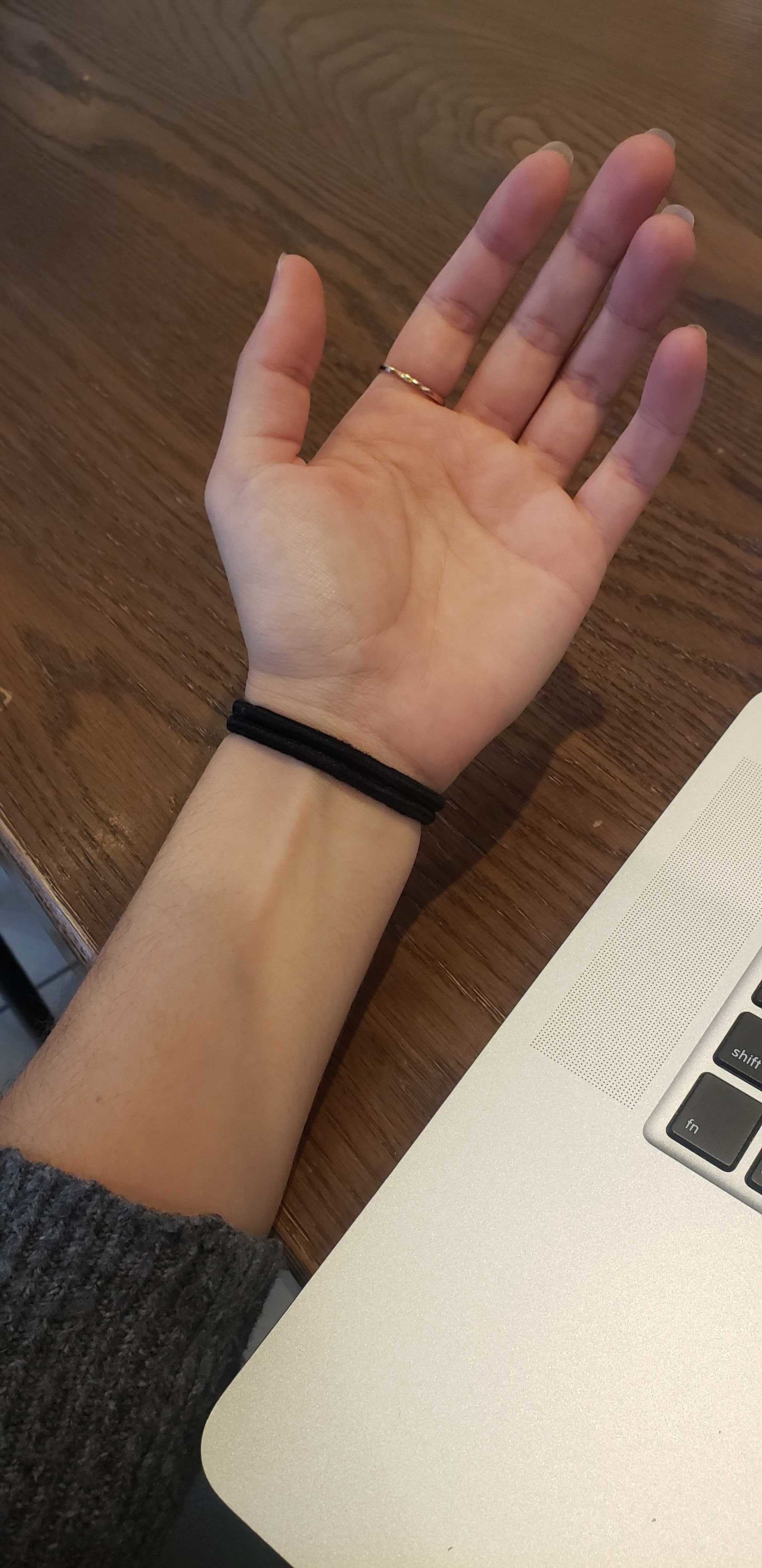 Two hair elastics worn on someone&#x27;s wrist