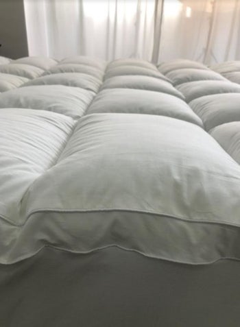 A reviewer's photo which shows the loft of the mattress topper