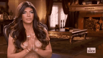 Teresa Giudice presses her hands together with her eyes closed and takes in a breath during her confessional on Real Housewives of New Jersey