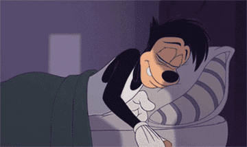 Max holds his teddy bear as he snuggles into bed in A Goofy Movie
