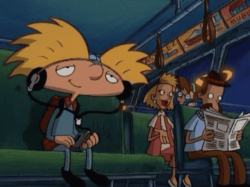 Arnold taps on his knee and bobs his head along as he listens to music through his headphones while on the bus in Hey Arnold