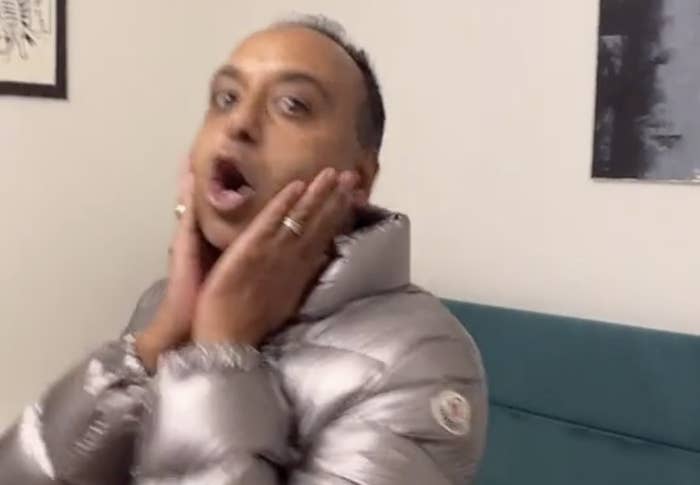 A dad in a silver jacket pretends to look shocked
