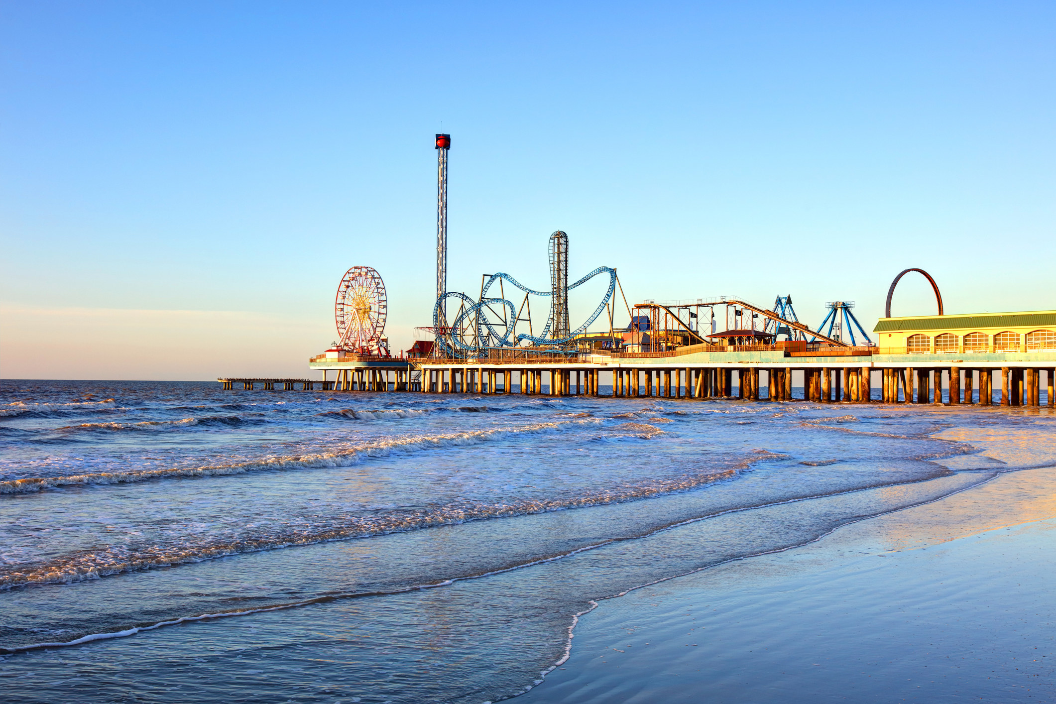 Island pier with amusement park rides and a beach