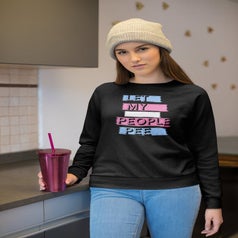 a model wearing the let my people pee sweater with blue, pink, and white lettering