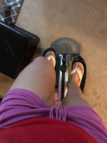 Reviewer pic of them standing on the elliptical and showing how small and compact it is