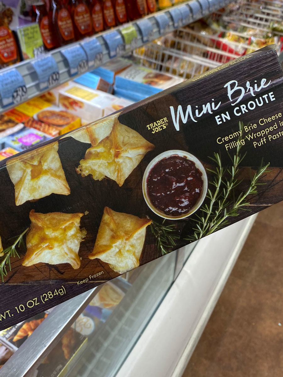 A box of mini brie en croute pastries.