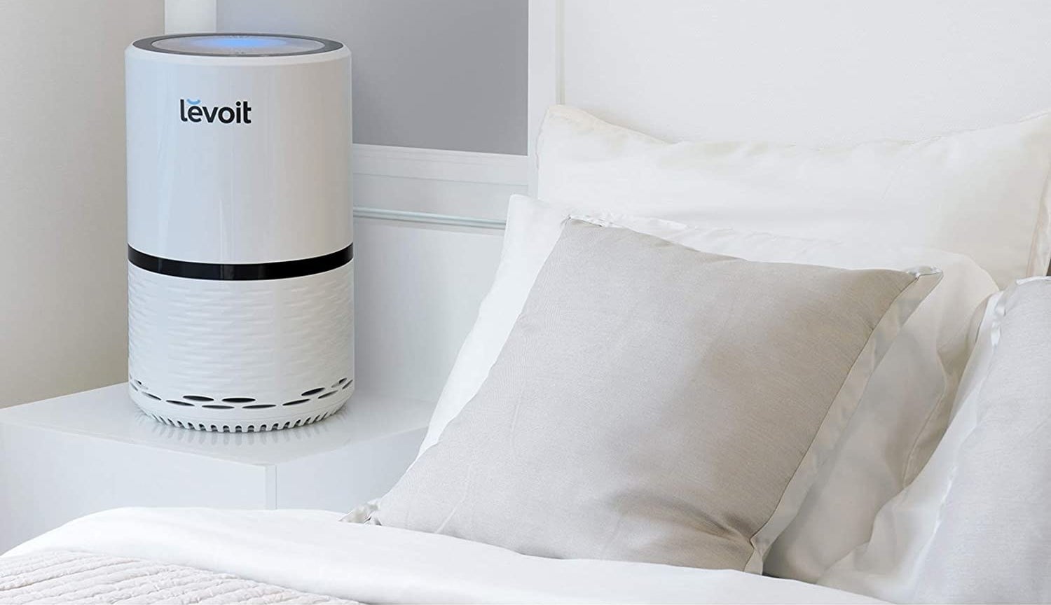 White air purifier with black accents and a blue light 