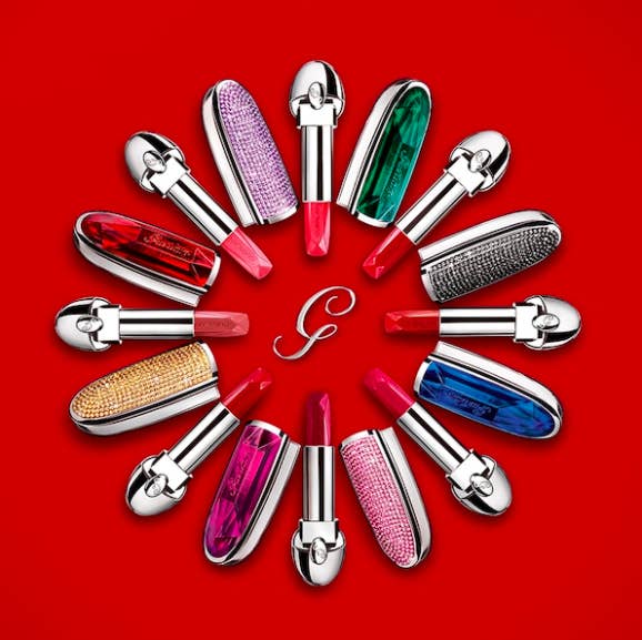A circle made up of glitzy lipstick cases and open lipstick tubes