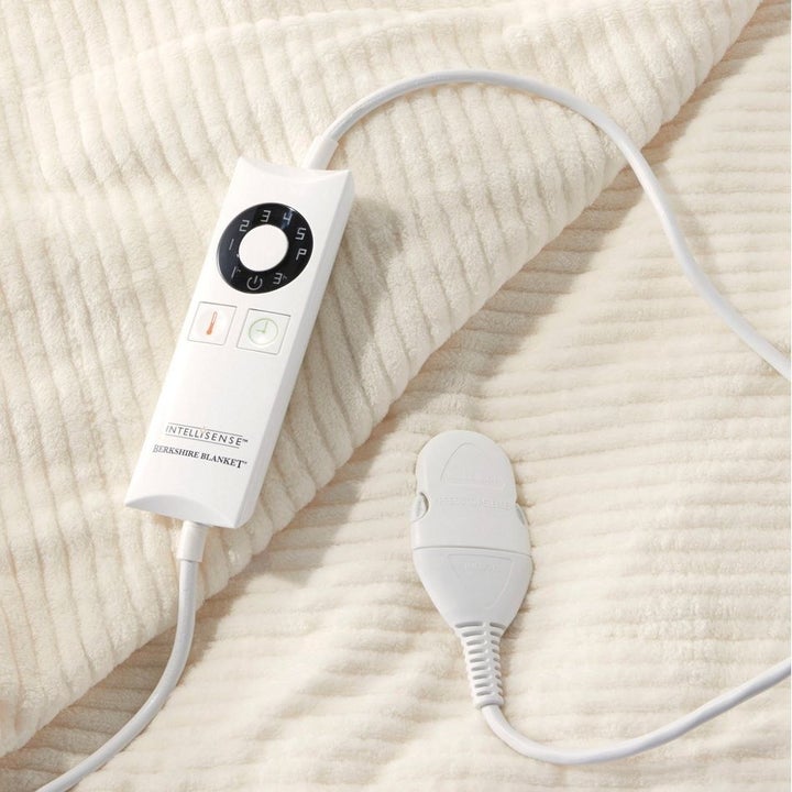 The blanket in cream with its remote
