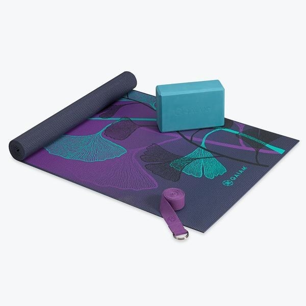 The kit with a yoga block, mat, and strap 