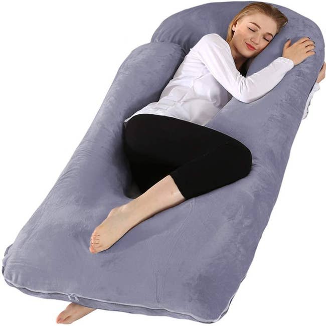 A model using the body pillow in purple grey