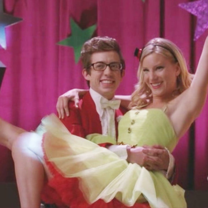 Artie holding Brittany in his lap as they pose for their prom picture