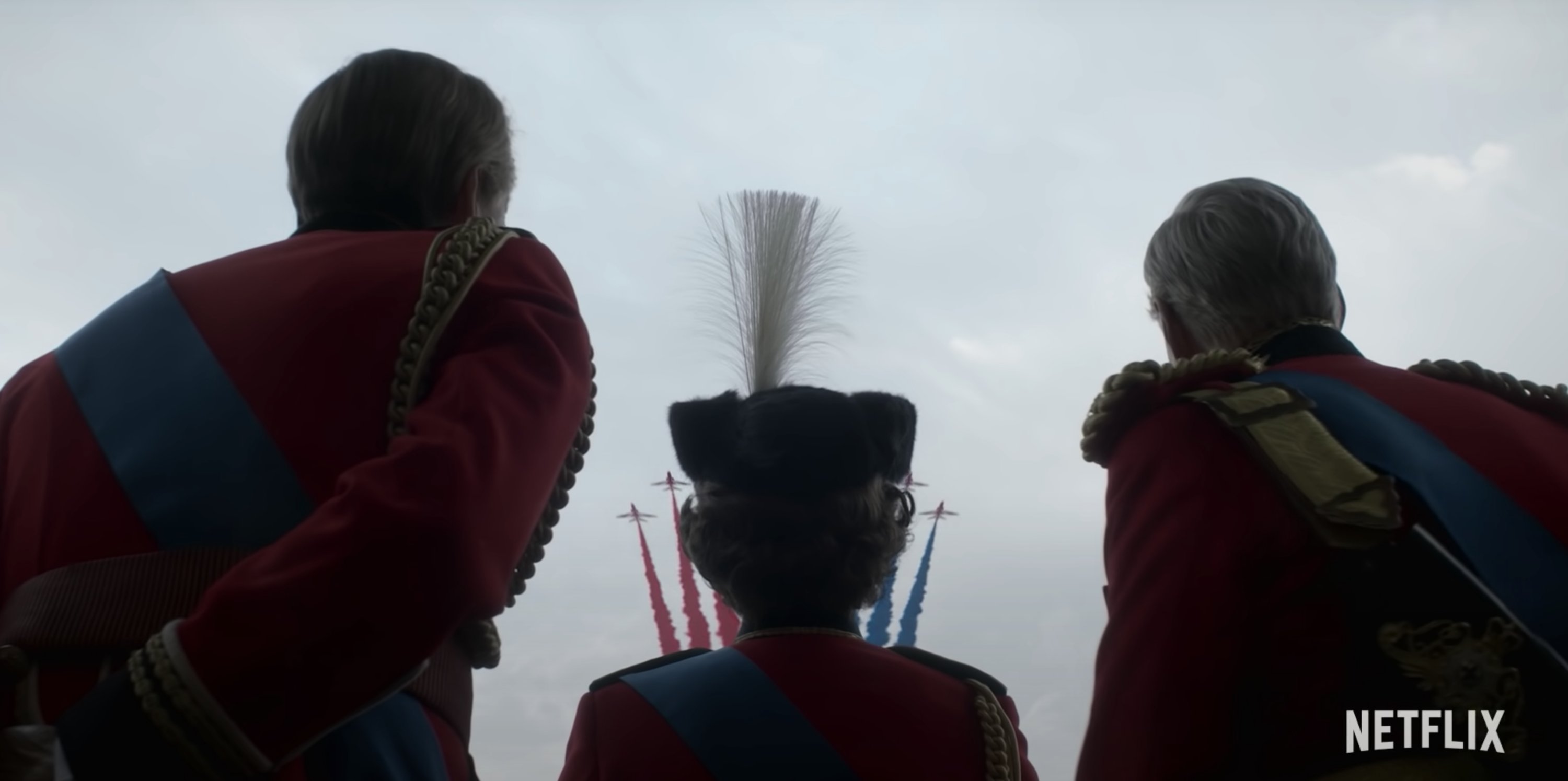 A silhouette shot of Queen Elizabeth II as she watches military planes fly past