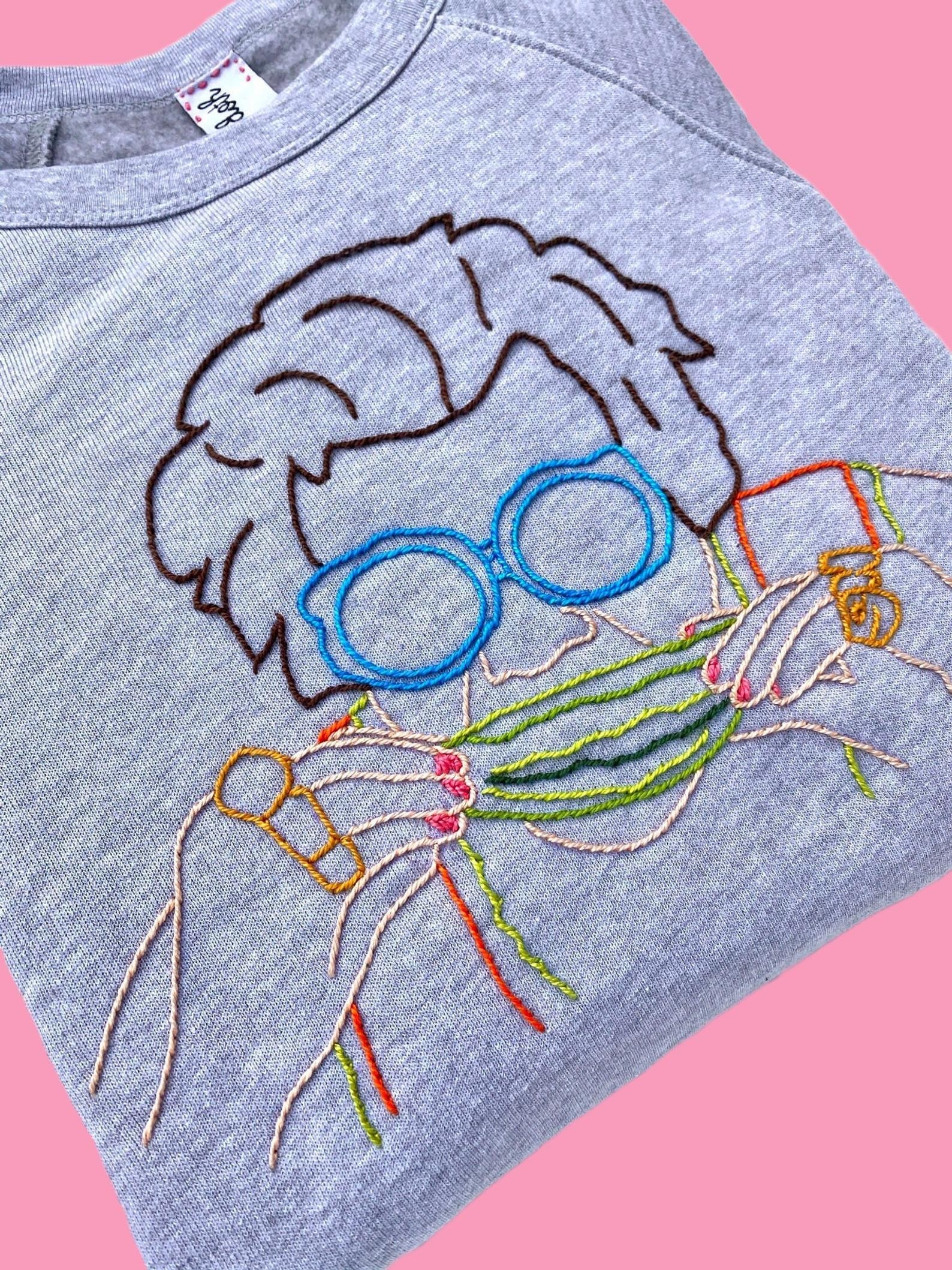 The grey sweatshirt with multicolored embroidery