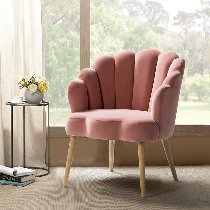 pink clamshell velvet chair with wooden legs